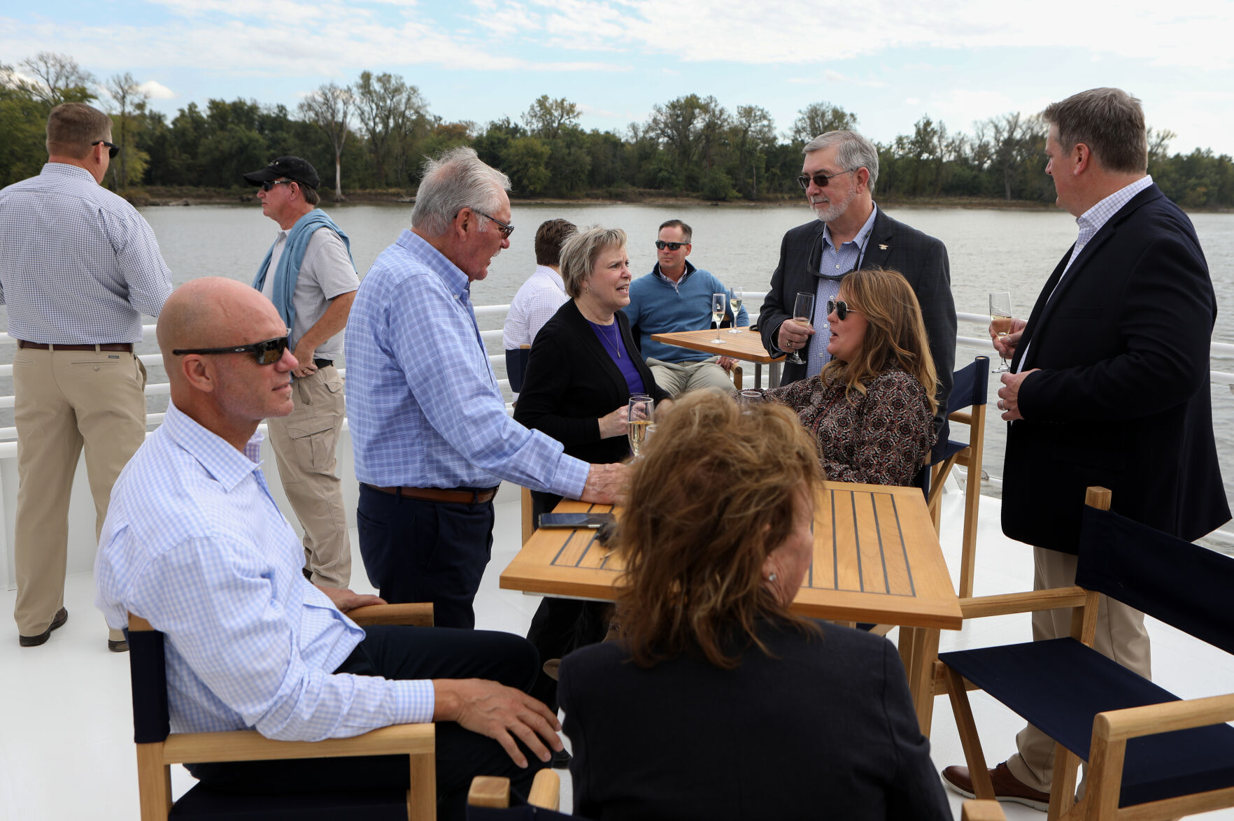 Passengers wine and converse aboard yacht